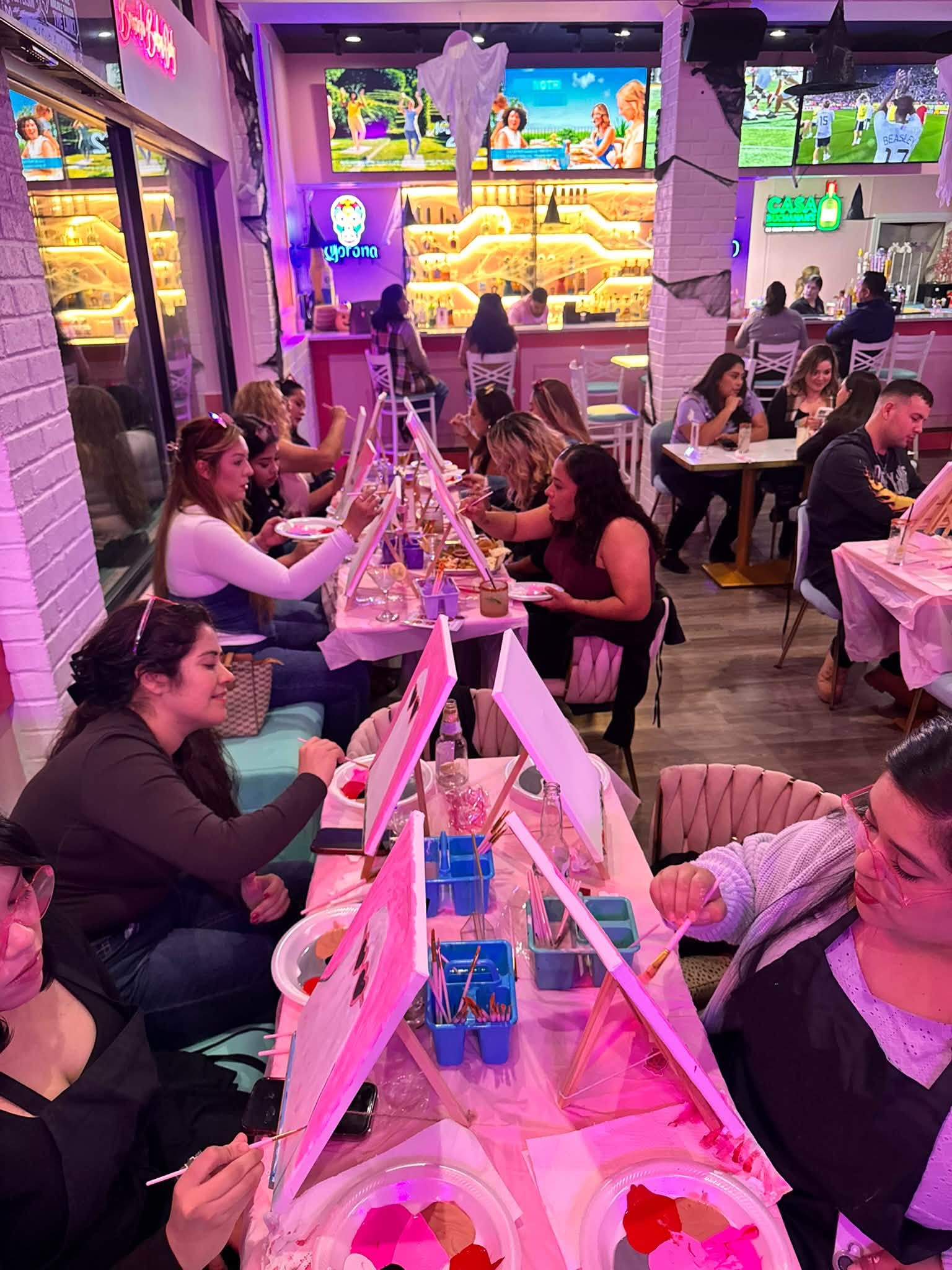 Guests enjoying a guided painting party with Honey's Painting